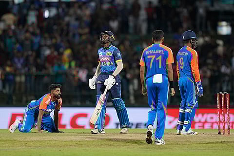 Sri Lanka's Chamindu Wickramasinghe reacts as the scores equals leading to a supper over